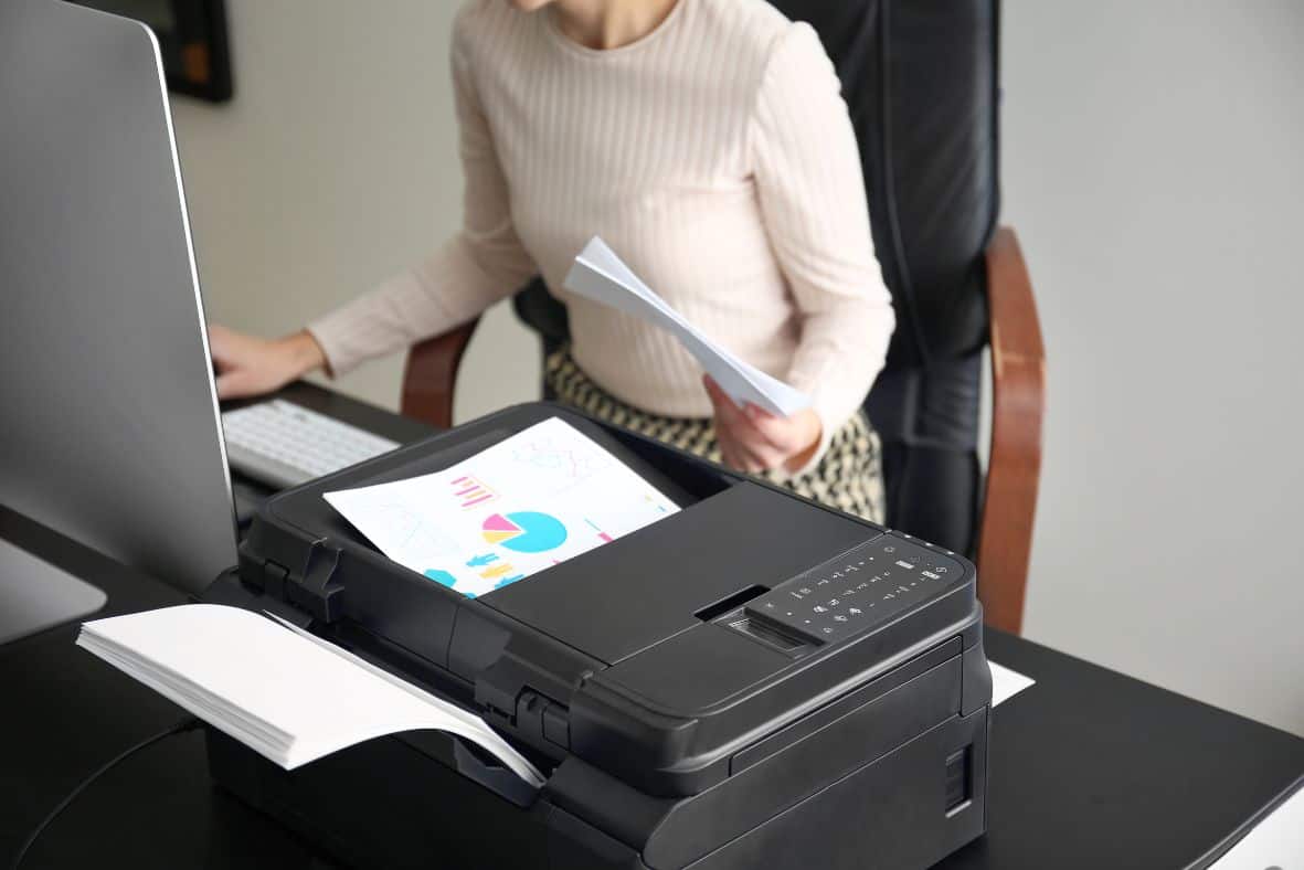 Photo of a school teacher printing educational material for a lesson